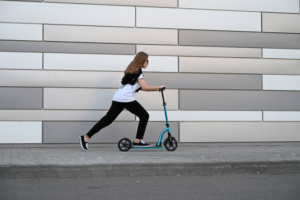 istock Beautiful and blonde girl practicing long board on the road 1492336570