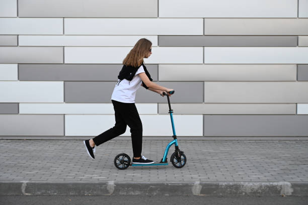 istock Beautiful and blonde girl practicing long board on the road 1492336585