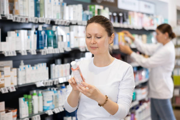 istock Young female shopper carefully chooses cosmetics in pharmacy 1492337821