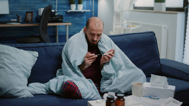 istock Person with sickness looking at tablets of capsules 1492338585