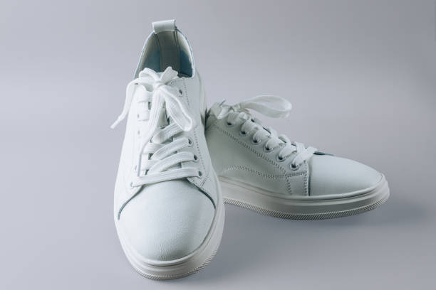 istock White leather sneakers on gray background. 1492340265