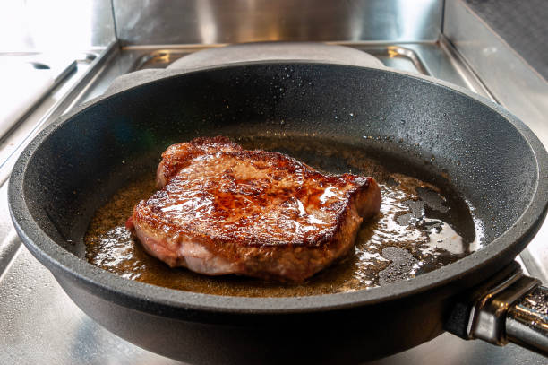istock Raw prime rib in pan with melted butter 1492340456