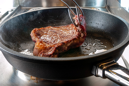 Raw prime rib in a pan, close-up.