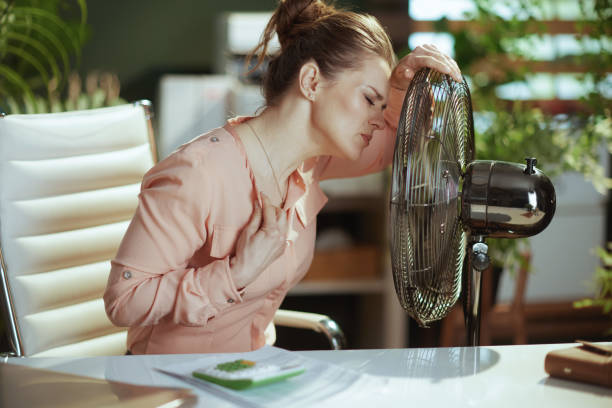 istock 40 years old woman worker at work suffer from heat 1492341905