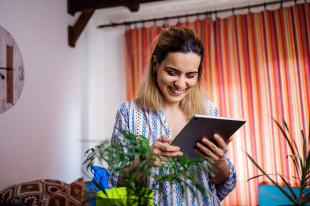 istock Smiling woman surfing the net on digital tablet 1492343629
