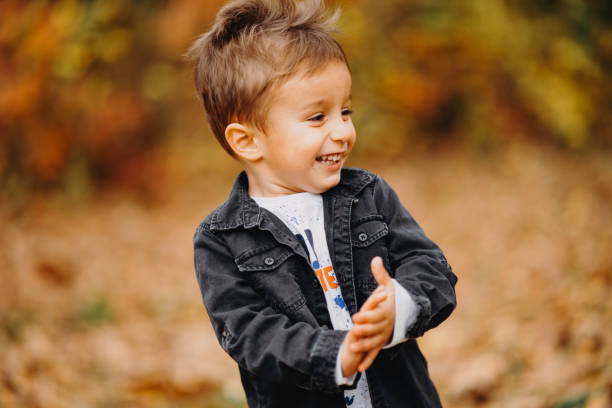 istock Child in the forest smiling and playing 1492345620