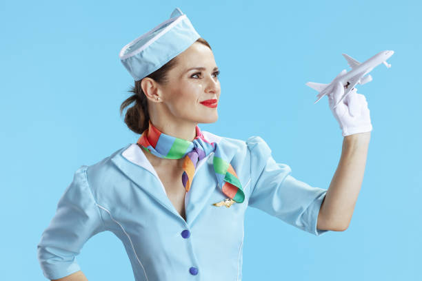 istock stylish flight attendant woman on blue 1492345826