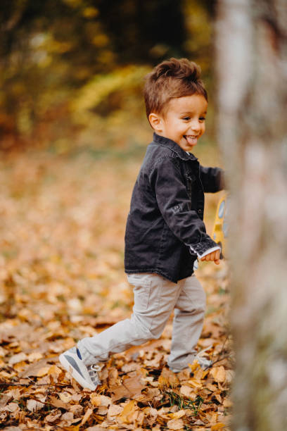 istock Child in the forest smiling and playing 1492346070