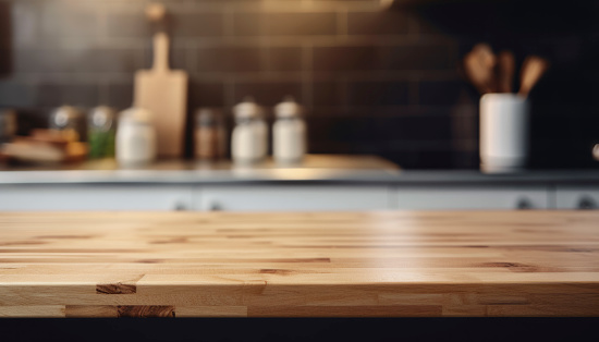 Beautiful empty brown wooden table top and blurred defocused modern kitchen interior background with day light flare, product montage display