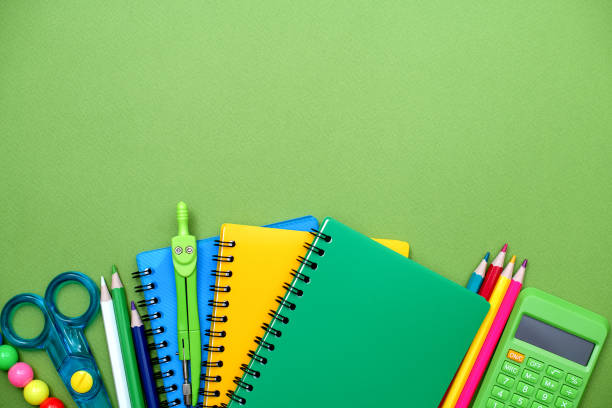 istock Collection different bright school stationery  and notebooks on green background, flat lay. Back to school concept. 1492348948
