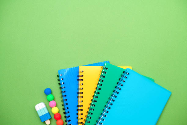 istock Collection different bright school stationery  and notebooks on green background, flat lay. Back to school concept. 1492349013