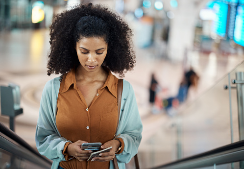Travel, phone and escalator with black woman in airport for social media, relax and networking. Flight, departure and holiday with girl passenger browsing for communication, vacation and contact