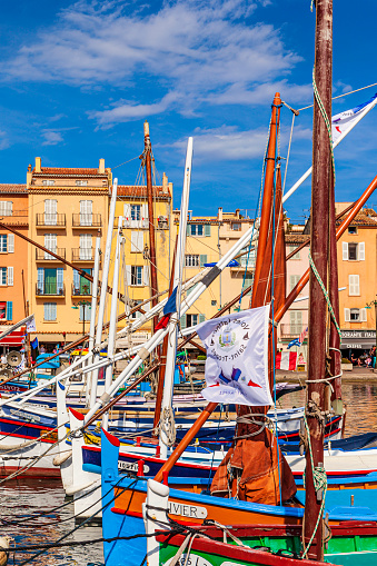 Traditional and colorful boats are moored at the port of Saint-Tropez, one of the most visited and glamour cities in the French Riviera
