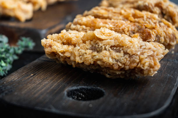 istock Spicy deep fried breaded chicken wings on old dark wooden table 1492354585