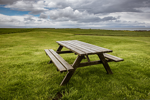 Bench, table and a grill with a view over the water in a public park in Ishøj which is a suburb south of Copenhagen