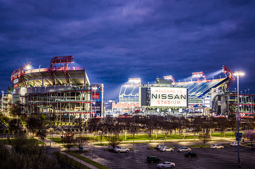 Nashville, USA - A view of the Nissan Stadium, close to downtown Nashville, illuminated at dusk.