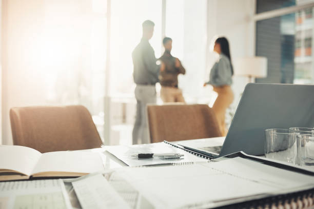 istock Desk, paperwork and notebook with laptop in office, professional workspace and setup, folder and planning. Strategy, documents and research, busy with business proposal with meeting and information 1492359264