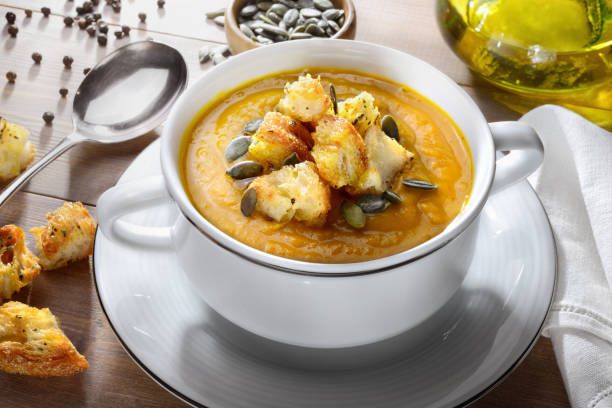 istock Pumpkin soup with croutons and pumpkin seeds, close-up. 1492361747