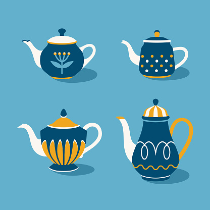 Collection of rustic painted teapots in blue and yellow colors. Kitchen utensils.