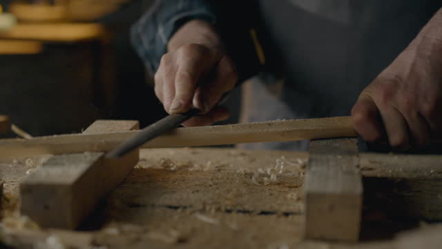 Hands, Workshop Worker Slowly Uses Hand Tool Rasp In Carpentry Workshop Close-up Woodworking