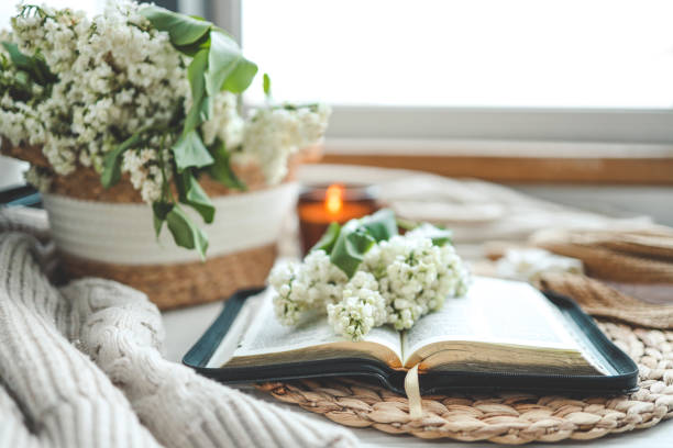 istock Open bible and white lilac branch, christian concept 1492366243