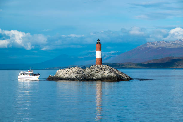 Les eclaireurs lighthouse, ushuaia, argentina King cormorants colony and trip ship at famous les eclaireurs lighthouse, ushuaia, argentina tierra del fuego, argentina beagle channel stock pictures, royalty-free photos & images