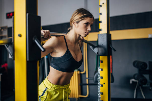 istock Young woman exercising in gym 1492366480