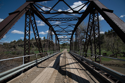 Old wood and steel bridge over the Musselshell river in central Montana in western USA of North America.