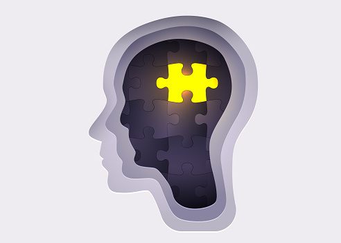 Silhouette of a human head with jigsaw puzzle. Concept of mental health and psychology. Vector illustration