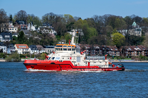Hamburg, Germany - 04 17 2023: View of the fire-fighting boat Branddirektor Westphal on the Elbe in Hamburg