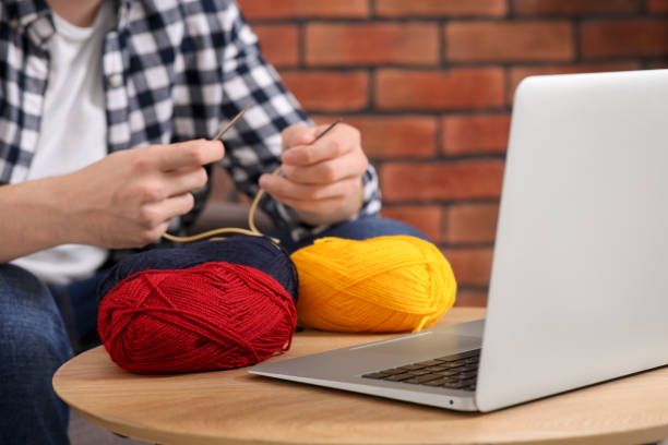 istock Man learning to knit with online course at home, closeup. Time for hobby 1492372100