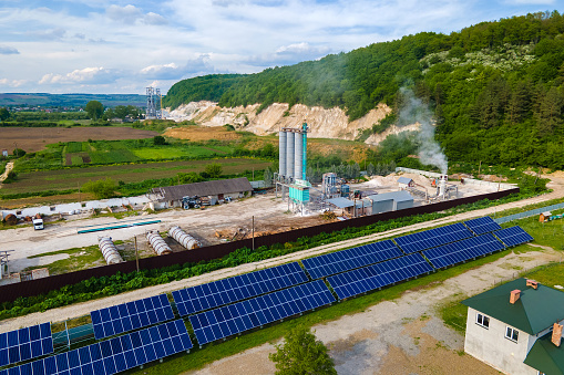 Aerial view of electrical power plant with rows of solar photovoltaic panels for producing clean ecological electric energy at industrial area. Renewable electricity with zero emission concept.
