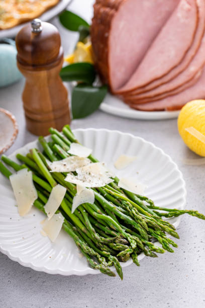 istock Asparagus cooked on a plate topped with parmesan 1492373702