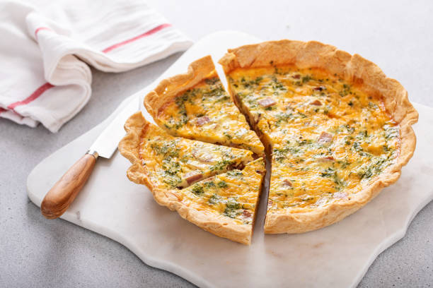 istock Homemade quiche with ham and cheese cut on the table 1492373931