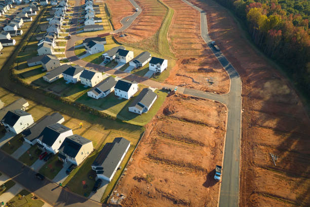 Ground prepared for building of new residential houses in South Carolina suburban development area. Concept of growing american suburbs Ground prepared for building of new residential houses in South Carolina suburban development area. Concept of growing american suburbs. basement construction site construction blueprint stock pictures, royalty-free photos & images