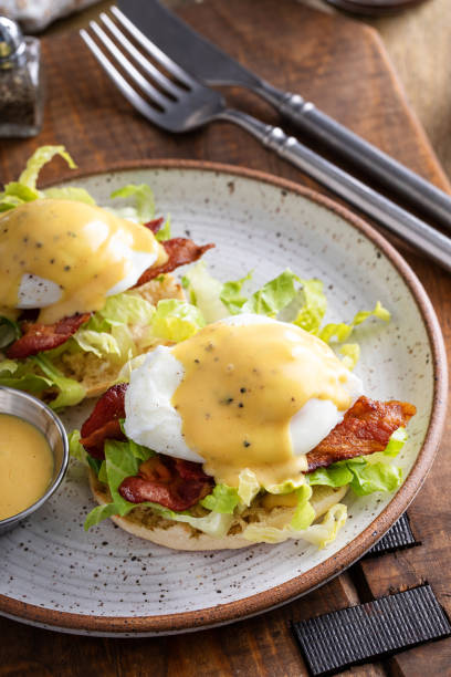 istock Eggs Benedict with bacon and lettuce on english muffins 1492374769