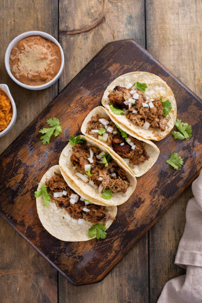 istock Pork carnitas tacos on a cutting board 1492375058