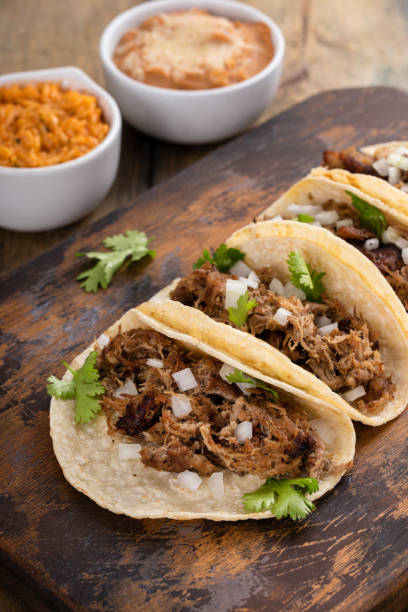 istock Pork carnitas tacos on a cutting board 1492375060