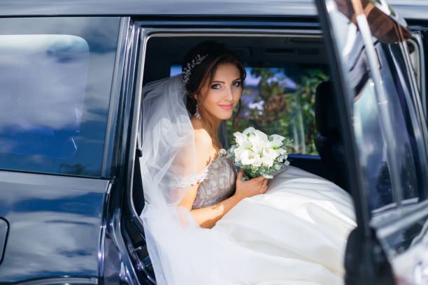 istock cute bride sits in a black car on the wedding day with a bouquet 1492376022