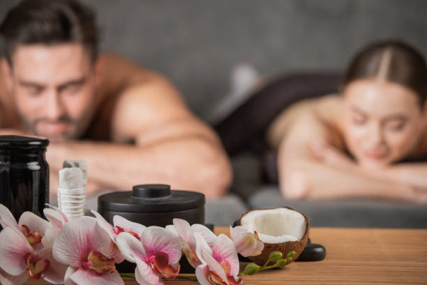 Couple lying in spa salon stock photo