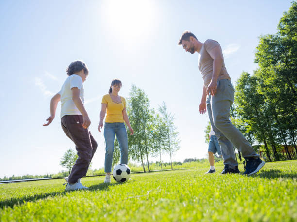 Free Stock Photo of Family playing soccer together in park | Download ...