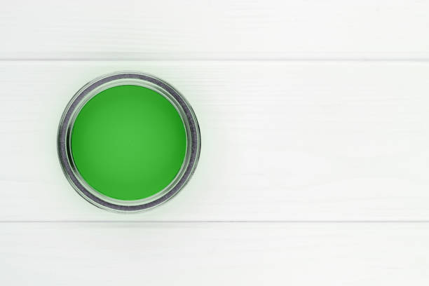 istock open can with green paint on a white wooden background top view with copy space 1492379250