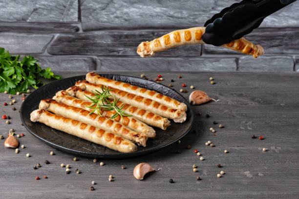 istock Fresh fried chicken sausages in a plate on a gray table. Empty copy space 1492379625