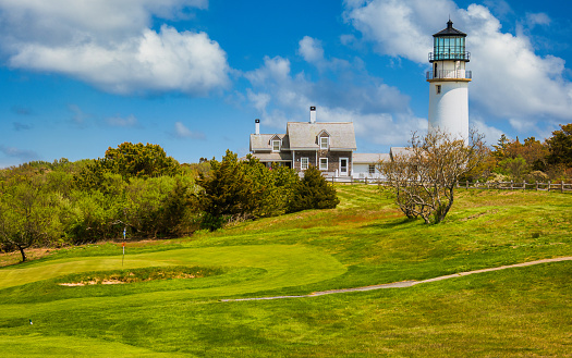 North Truro, Massachusetts, USA -May 11, 2023-Cape Cod's oldest golf course, Highland Links (1892),  is built adjacent to Cape Cod lighthouse.  This public course offers deep natural rough, Scotch broom, heath, and spectacular ocean views.