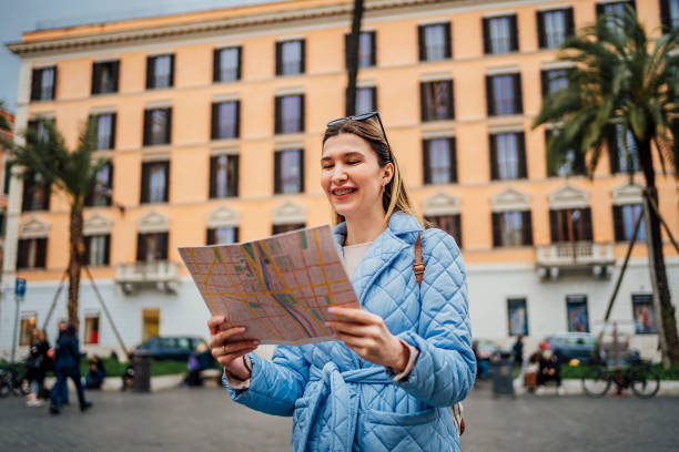 istock Woman tourist using a map on Piazza de Spagna, Rome 1492385996