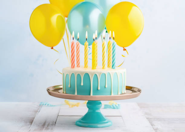 istock Birthday cake with drip icing and party balloons 1492387315