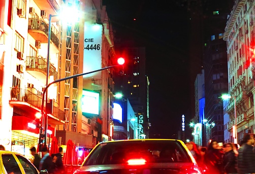 Buenos Aires, Argentina -10/05/2019  Avenida Corrientes at night. Corrientes Avenue - Avenida Corrientes is one of the principal thoroughfares of the Argentine capital of Buenos Aires. The street is intimately tied to the tango and the porteño sense of identity.The Avenue is home to numerous theaters and bars, which have made it the center of the night life of the Argentine capital. On Avenida Corrientes there is an Obelisk, city theaters, and many bookstores.