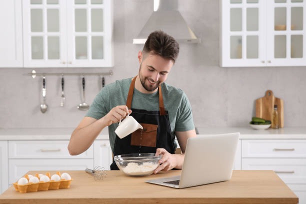 istock Happy man learning to cook with online video on laptop at table in kitchen. Time for hobby 1492388014