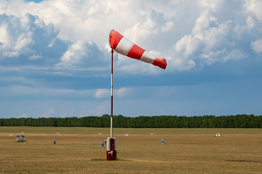 Airport wind sock. Strong wind and bad weather symbol. Climate change. Meteorology forecast. Storm is coming.