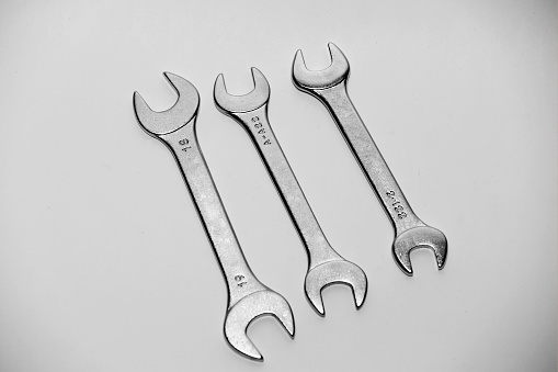 Set spanner wrench to repair machines table top view isolated on white background.